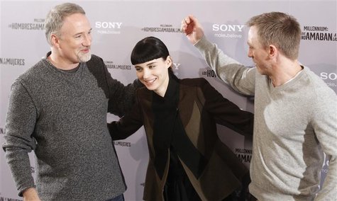 Cast members Craig and Mara pose with director Fincher during the media presentation of their movie "The Girl with the Dragon Tattoo" in Mad Cast members Craig and Mara pose with director Fincher during the media presentation of their movie "The Girl with the Dragon Tattoo" in Mad