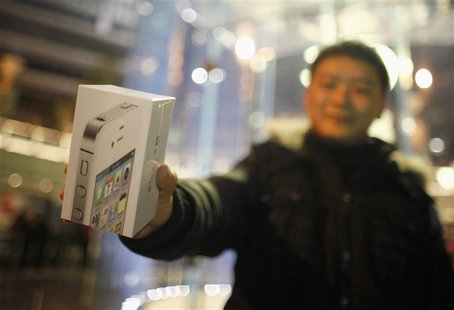 A customer show his iPhone 4S after making the purchase at Apple's retail store in downtown Shanghai A customer show his iPhone 4S after making the purchase at Apple's retail store in downtown Shanghai