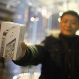 A customer show his iPhone 4S after making the purchase at Apple's retail store in downtown Shanghai A customer show his iPhone 4S after making the purchase at Apple's retail store in downtown Shanghai