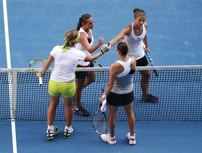 Kuznetsova of Russia and Zvonareva of Russia shake hands with Errani of Italy and Vinci of Italy after their women's doubles final match in Kuznetsova of Russia and Zvonareva of Russia shake hands with Errani of Italy and Vinci of Italy after their women's doubles final match in