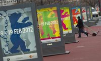 Man walks past posters advertising upcoming Berlinale international film festival in Berlin