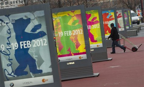 Man walks past posters advertising upcoming Berlinale international film festival in Berlin