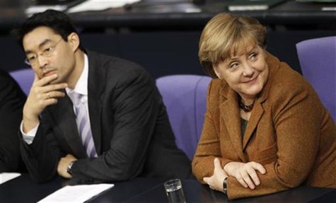 German Economy Minister Roesler and Chancellor Angela Merkel attend a session of the lower house of parliament Bundestag in Berlin German Economy Minister Roesler and Chancellor Angela Merkel attend a session of the lower house of parliament Bundestag in Berlin
