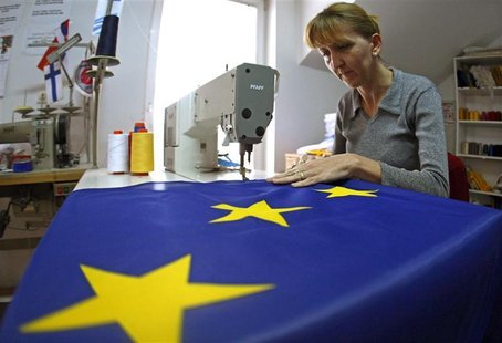 A seamstress sews a European Union (EU) flag in a small workshop in Belgrade A seamstress sews a European Union (EU) flag in a small workshop in Belgrade