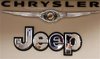 Pro Chrysler Jeep staff members are reflected in a sign at the Chrysler dealership during a meeting in Thornton