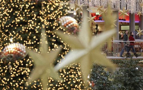 Shoppers walk among illuminated Christmas decorations in a shopping mall at Berlin's Potsdamer Platz Shoppers walk among illuminated Christmas decorations in a shopping mall at Berlin's Potsdamer Platz