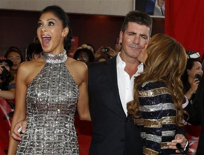 Paula Abdul kisses the cheek of Simon Cowell as Nicole Scherzinger reacts at the world premiere of "The X Factor" in Hollywood Paula Abdul kisses the cheek of Simon Cowell as Nicole Scherzinger reacts at the world premiere of "The X Factor" in Hollywood