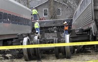 Train derailment workers work on site where a Amtrak train, headed for Chicago, carrying 68 passengers and five crew members struck a semitr