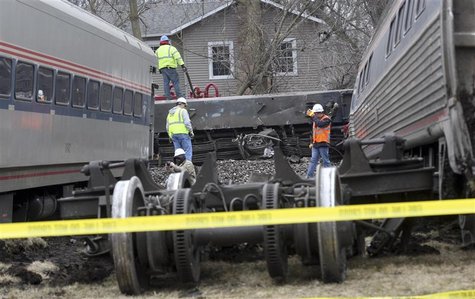 Train derailment workers work on site where a Amtrak train, headed for Chicago, carrying 68 passengers and five crew members struck a semitr