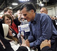 U.S. Republican presidential candidate Romney shakes hands as he mingles with the crowd at a campaign stop in Eagan