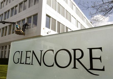 A worker uses a mobile lift to clean the windows of the headquarters of Swiss commodities trader Glencore in Baar near Zurich