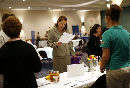 A woman reads an application at a job fair A woman reads an application at a job fair