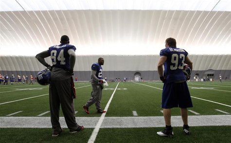 Giants players Kiwanuka, Martin, and Blackburn wait on the sidelines during practice for the NFL Super Bowl XLVI in Indianapolis Giants players Kiwanuka, Martin, and Blackburn wait on the sidelines during practice for the NFL Super Bowl XLVI in Indianapolis