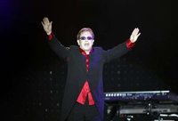British singer Elton John greets his fans before his concert in Istanbul July 5, 2011. REUTERS/Osman Orsal (TURKEY - Tags: SOCIETY ENTERTAINMENT PROFILE)