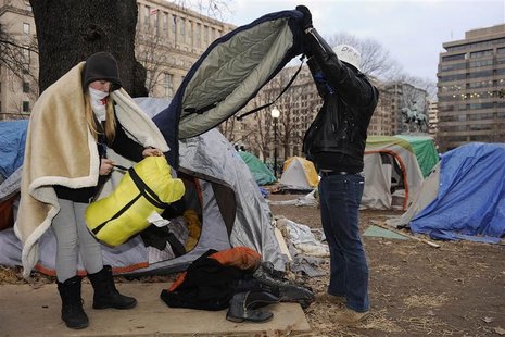 Protesters pack their personal belongings from their tents as U.S. National Park Service police cordon-off the Occupy DC encampment in McPhe Protesters pack their personal belongings from their tents as U.S. National Park Service police cordon-off the Occupy DC encampment in McPhe