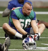 Giants linebacker Herzlich stretches during practice for the NFL Super Bowl XLVI in Indianapolis