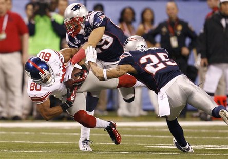 New York Giants' Cruz is tackled by New England Patriots' Moore and Chung in the first quarter of the NFL Super Bowl XLVI football game in I New York Giants' Cruz is tackled by New England Patriots' Moore and Chung in the first quarter of the NFL Super Bowl XLVI football game in I