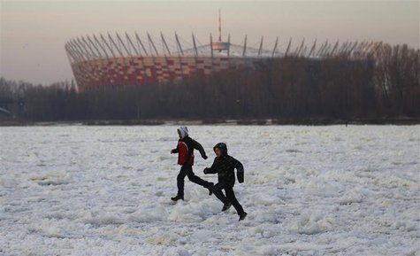 A group of children cross the frozen Vistula River between Poniatowski and Lazienkowski Bridge in the centre of Warsaw A group of children cross the frozen Vistula River between Poniatowski and Lazienkowski Bridge in the centre of Warsaw