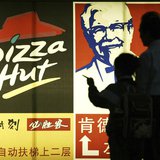 File photo of people standing in front of a poster of KFC and Pizza Hut in Guangzhou File photo of people standing in front of a poster of KFC and Pizza Hut in Guangzhou