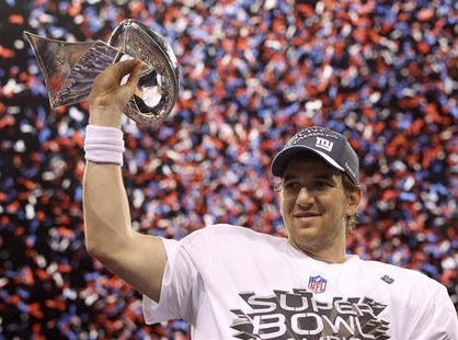 New York Giants quarterback Eli Manning holds the Vince Lombardi Trophy after defeating the New England Patriots