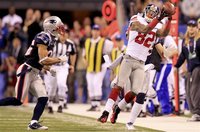 New York Giants wide receiver Mario Manningham makes a catch as New England Patriots free safety Patrick Chung (L) watches during the fourth