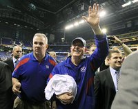 New York Giants head coach Tom Coughlin waves to fans as he leaves the field after the Giants defeated the New England Patriots in the NFL S