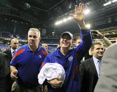 New York Giants head coach Tom Coughlin waves to fans as he leaves the field after the Giants defeated the New England Patriots in the NFL S