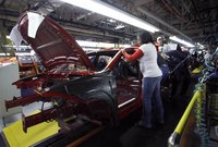 Workers assemble a pre-production 2013 Dodge Dart during a tour of the Chrysler Belvidere Assembly plant in Belvidere