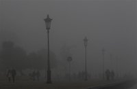 People walk on a promenade during a foggy day in Thessaloniki