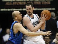 Timberwolves forward Love drives against Mavericks forward Cardinal in Minneapolis