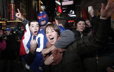 Fans of New York Giants celebrate their victory over New England Patriots in Times Square following the Super Bowl XLVI football game in New