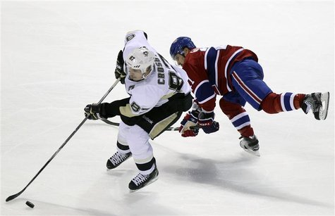 Penguins' Crosby avoids check by Canadiens' Gionta during NHL hockey action in Montreal