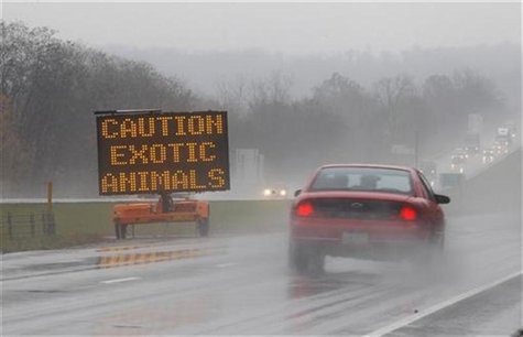 A sign posted on Interstate 70 warns drivers of animals loose in the area around Zanesville A sign posted on Interstate 70 warns drivers of animals loose in the area around Zanesville