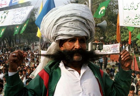 Ellahi Bakhsh Baluch, a Pakistani renowned for his thick mustache, poses on a stage during a nationl flag rally in Islamabad in this file ph