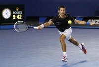 Djokovic of Serbia hits a return to Nadal of Spain during their men's singles final match at the Australian Open tennis tournament in Melbou