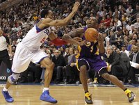 Los Angeles Lakers guard Bryant battles with the Philadelphia 76ers forward Iguodala during second quarter of their NBA basketball game in P