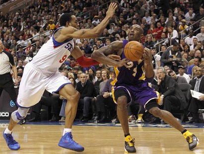 Los Angeles Lakers guard Bryant battles with the Philadelphia 76ers forward Iguodala during second quarter of their NBA basketball game in P Los Angeles Lakers guard Bryant battles with the Philadelphia 76ers forward Iguodala during second quarter of their NBA basketball game in P