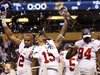 New York Giants (and former Michigan State) wide receiver Devin Thomas (C) holds the Vince Lombardi Trophy and celebrates with teammates Osi Umenyiora (L) and Mathias Kiwanuka after the Giants defeated the New England Patriots in the NFL Super Bowl XLVI football game in Indianapolis, Indiana, February 5, 2012.
REUTERS/Mike Segar
