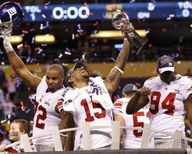 New York Giants (and former Michigan State) wide receiver Devin Thomas (C) holds the Vince Lombardi Trophy and celebrates with teammates Osi Umenyiora (L) and Mathias Kiwanuka after the Giants defeated the New England Patriots in the NFL Super Bowl XLVI football game in Indianapolis, Indiana, February 5, 2012.
REUTERS/Mike Segar New York Giants (and former Michigan State) wide receiver Devin Thomas (C) holds the Vince Lombardi Trophy and celebrates with teammates Osi Umenyiora (L) and Mathias Kiwanuka after the Giants defeated the New England Patriots in the NFL Super Bowl XLVI football game in Indianapolis, Indiana, February 5, 2012.
REUTERS/Mike Segar