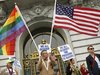 Billy Bradford waves flags outside City Hall after a judge lifted the Proposition 8 stay on same sex marriages at City Hall in San Francisco