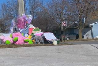 People are placing memorials near the house where De Pere authorities say a father shot his wife and two children on February 3, 2012. (courtesy of FOX 11).