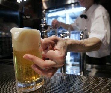 Server serves Sapporo draft beer at Sapporo Bier Garten in Sapporo Server serves Sapporo draft beer at Sapporo Bier Garten in Sapporo