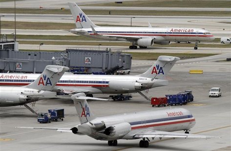 American Airlines planes sit at their gates while others taxi for arrival and departure at O'Hare International airport in Chicago American Airlines planes sit at their gates while others taxi for arrival and departure at O'Hare International airport in Chicago
