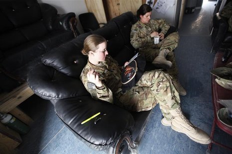 U.S. Army Specialist Nicole Derk of the C Company 3/82 Dustoff MEDEVAC cross stitches during her shift in Logar province