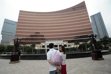 Tourists stand outside the Wynn Casino in Macau Tourists stand outside the Wynn Casino in Macau