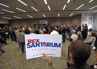 A supporter holds a sign as Republican presidential candidate Rick Santorum speaks at a rally in Minnesota