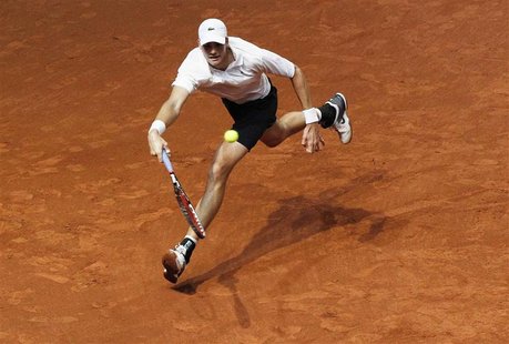Isner of the U.S. hits a return to Switzerland's Federer during their Davis Cup tennis match in Fribourg