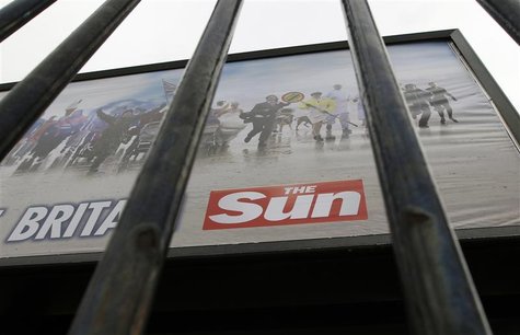 An advertisement for The Sun newspaper is seen on a billboard outside News International's Wapping headquarters in London