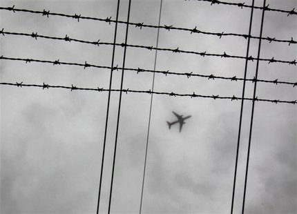 Airplane flies through low cloud above high tension electricity transmission cables in Sydney Airplane flies through low cloud above high tension electricity transmission cables in Sydney