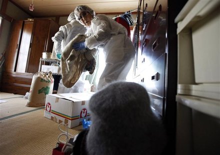 Miyoko Takeda retrieves her belongings at her home during her temporary return visit to Okuma town